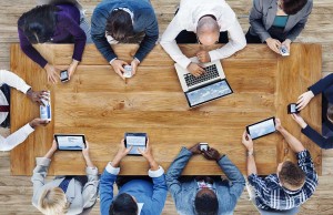 People at table with mobile devices